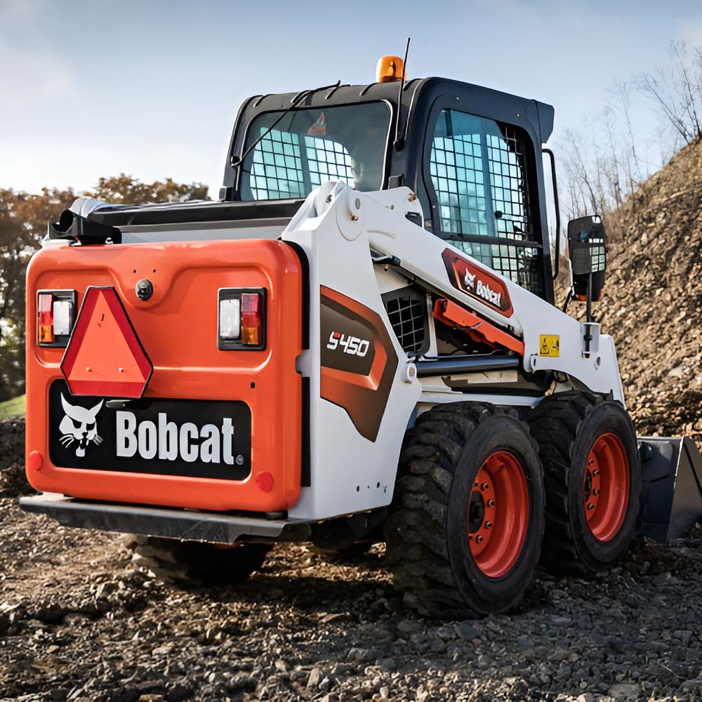 Bobcat S450 skid-steer loader on a gravel slope, rear view